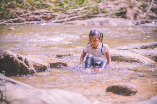 girls having fun playing in the waterfall