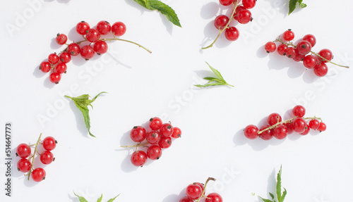  Ripe red currant berries and mint leaves on a white, pastel background.Flat lay, top view, photo