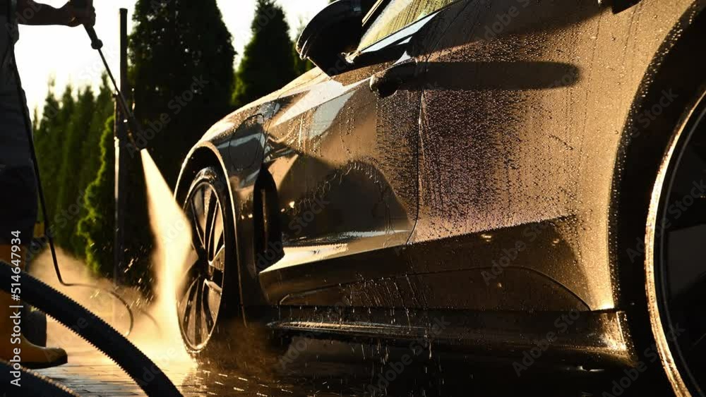 Men Washing His Car Using Pressure Washer