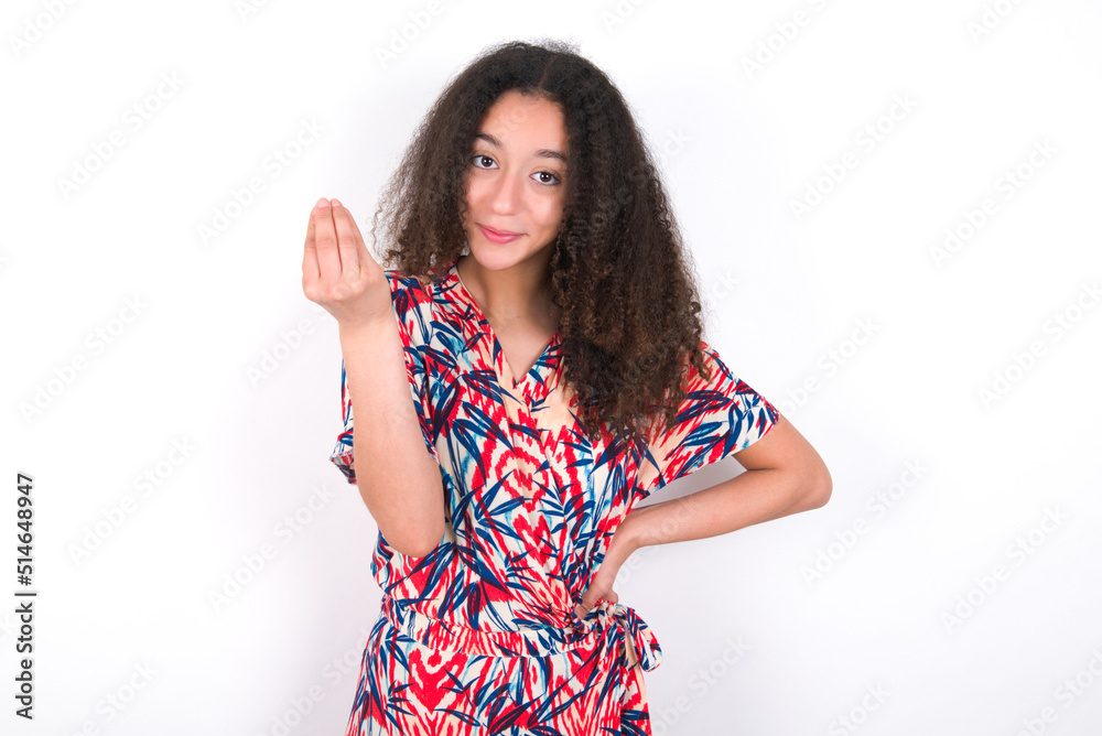 What the hell are you talking about. Shot of frustrated young beautiful girl with afro hai gesturing with raised hand doing Italian gesture, frowning, being displeased and confused with dumb question. What the hell are you talking about. Shot of frustrated young beautiful girl with afro hai gesturing with raised hand doing Italian gesture, frowning, being displeased and confused with dumb question.