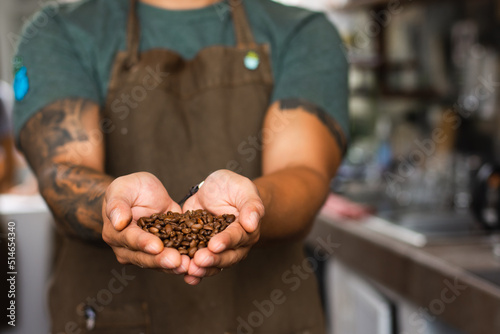 Hispanic unrecognizable man with coffee beans in his hands 