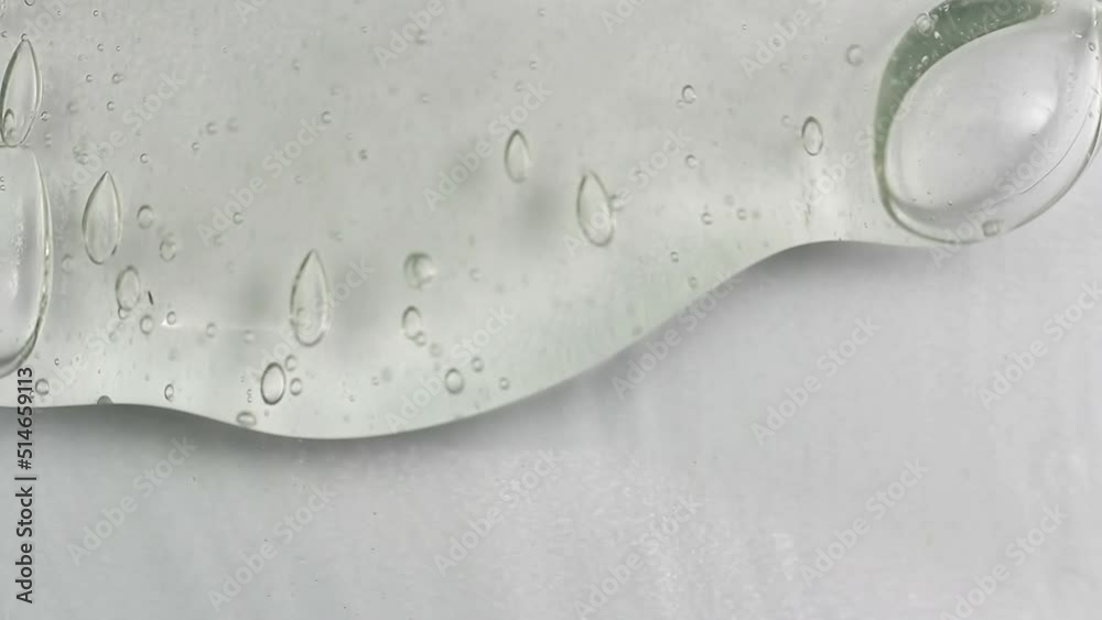 Clean transparent shampoo with bubble flowing from bottom. Macro cosmetic, cleaner texture background, isolated on white