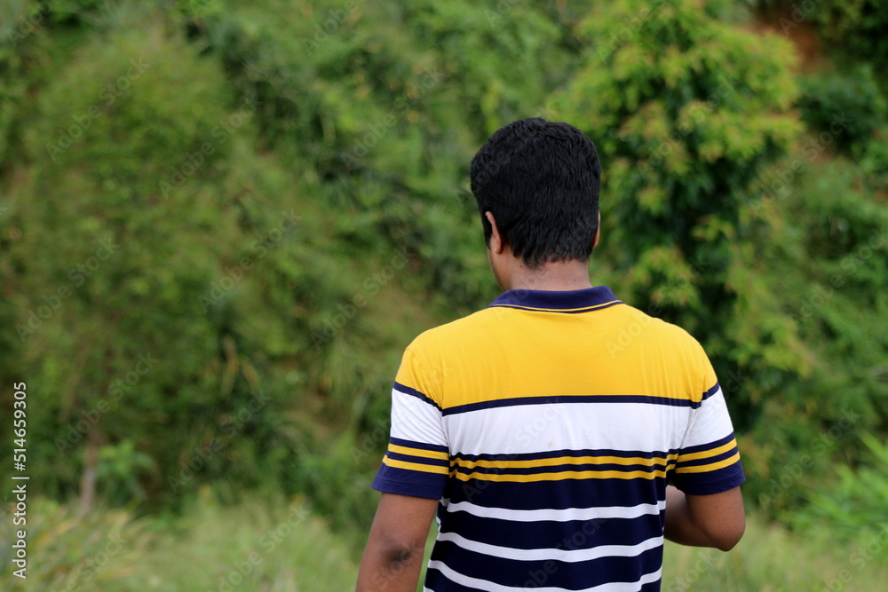 Naklejka premium A handsome and good looking person is stayed on the mountain with natural background.