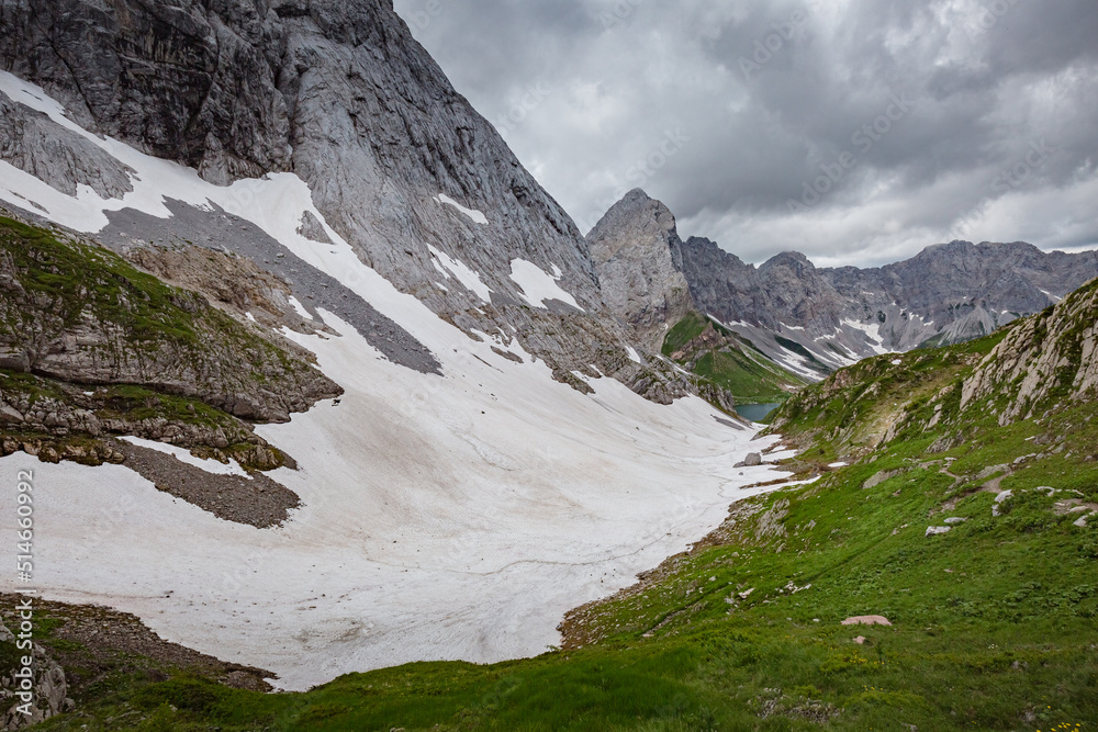Mountain hiking Trail Road. Small mountain lake. Between Italy and Austria: near Volaia Lake Raunchkofer Mountain (Lago di Volaia Monte Rauchkofel)