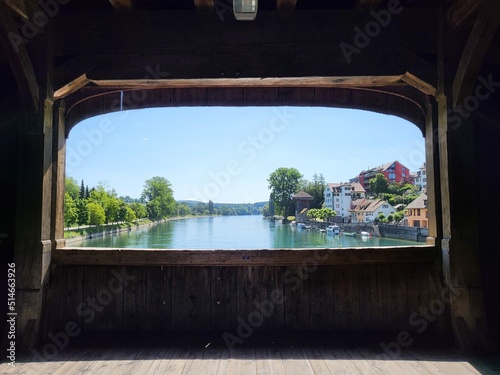 View towards river  Diessenhofen Switzerland town and Gailingen am Hochrhein Germany village  from the window of Rheinbrucke  an old wooden bridge connecting both place.