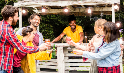 Canvas Print Happy mixed race people having fun at pool party on the rooftop while drinking