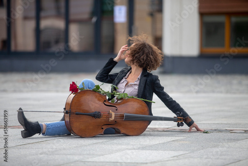 A female musician with a cello on the street photo