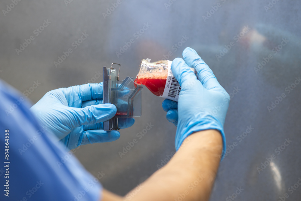Medical scientists preparing cytology specimens in a hospital laboratory. Medical scientists preparing cytology specimens in a hospital laboratory.