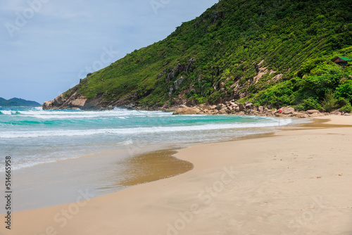 Sandy beach and ocean waves. Praia do Rio das Pacas in Brazil