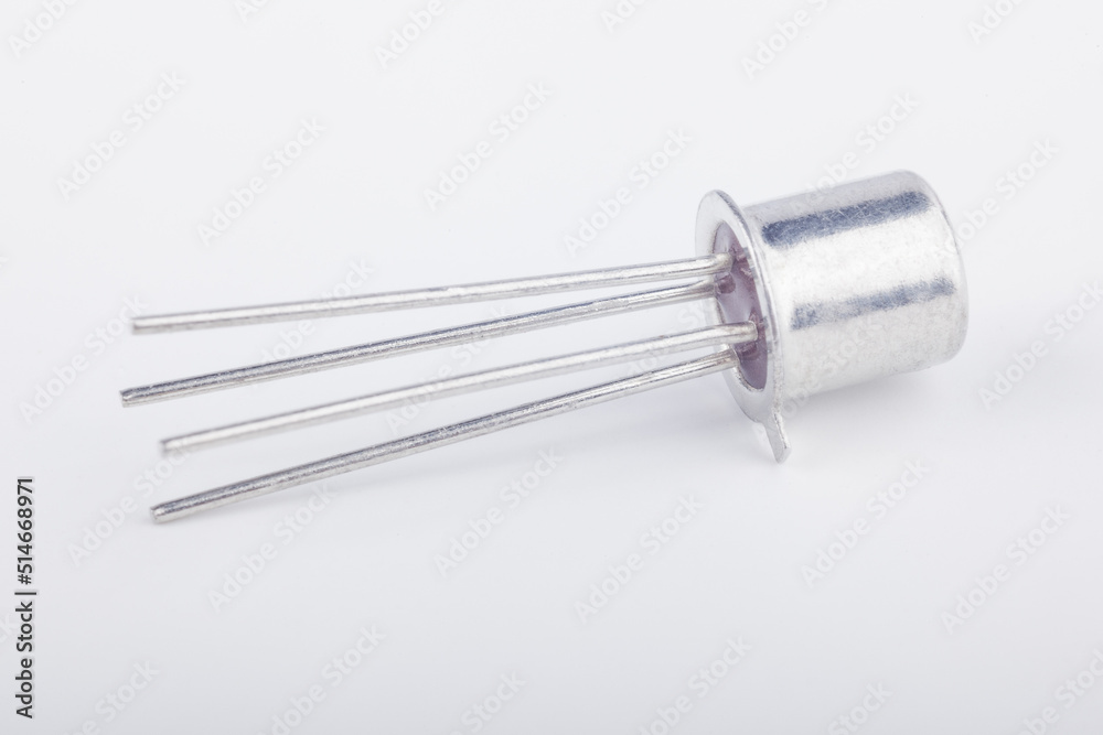 Old metal transistor BFY90 M8727 on white background. Electronic component. Vintage semiconductor device. Old metal transistor BFY90 M8727 on white background. Electronic component. Vintage semiconductor device.