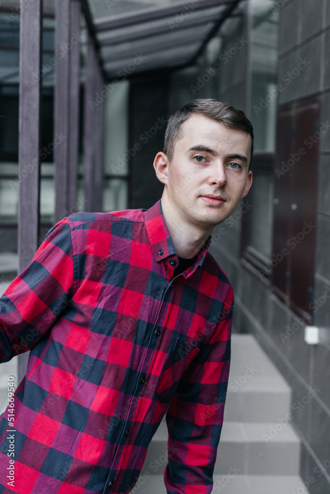 young handsome guy in a red checkered shirt young handsome guy in a red checkered shirt