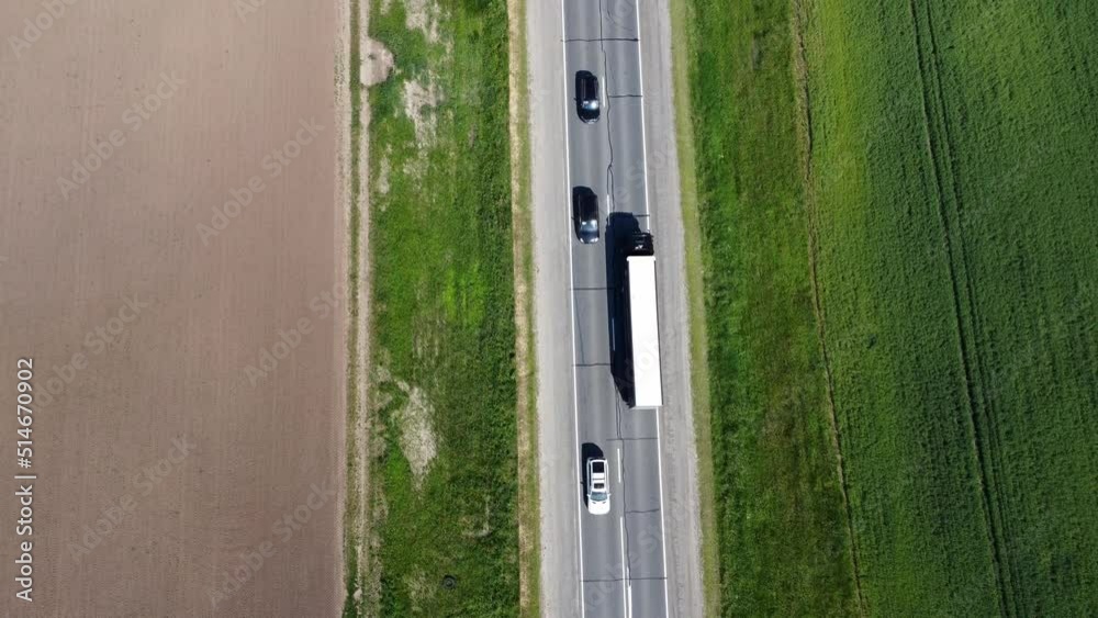 view of the highway from a quadrocopter. Car driving along the highway in the woods on a summer day. View from a height Stock video footage Shot in 4k format, Drone video Delivery Road Highway. view of the highway from a quadrocopter. Car driving along the highway in the woods on a summer day. View from a height Stock video footage Shot in 4k format, Drone video Delivery Road Highway.