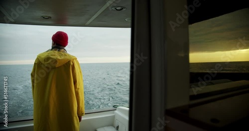 fisherman on a boat looking out to sea