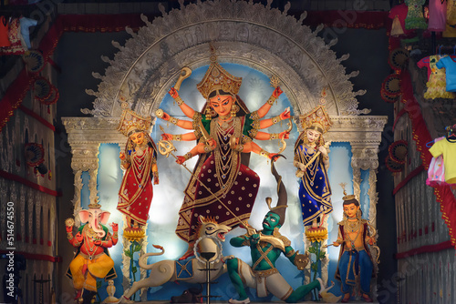 Idol of Goddess Devi Durga at a decorated puja pandal in Kolkata, West Bengal, India. Durga Puja is a famous and major religious festival of Hinduism that is celebrated throughout the world. photo
