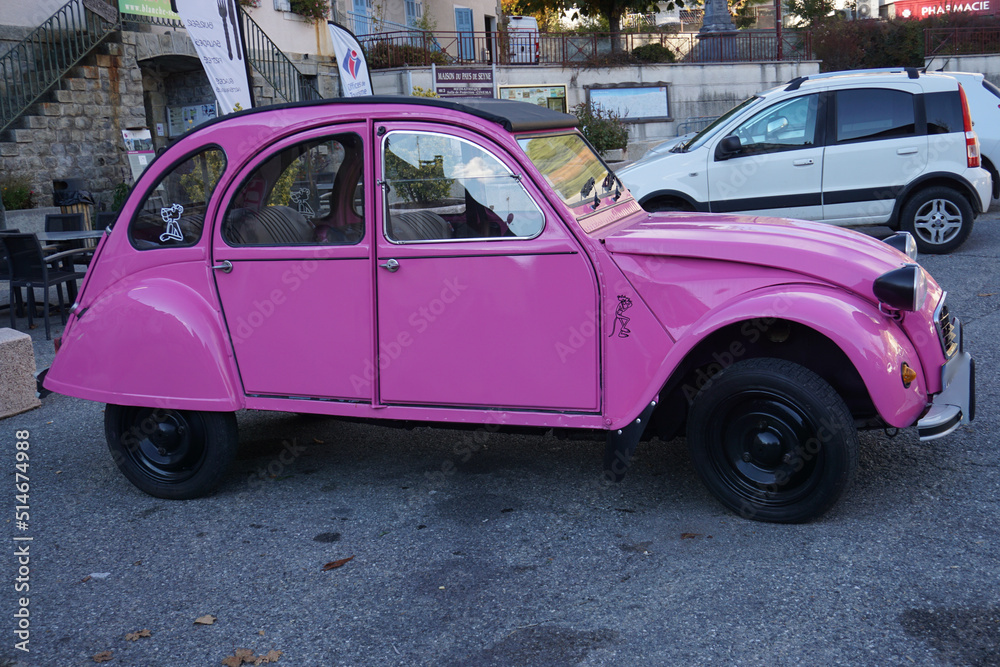 pink 2 CV parked in the street in france