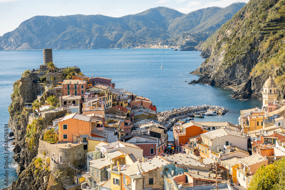 Landscape of coastline with Vernazza village in Italy on sunny day. Famous town in Cinque Terre region in northwestern Italy. Traveling italian landmarks concept