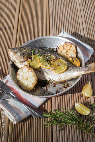 Delicious Grilled dorado fish with lemon and parsley. Whole Bbq sea bream baked. Dorado grill. Ketogenic, keto or paleo diet lunch, Healthy food trend. Top view,