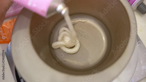 Mixing oxider and dye in a hair coloring bowl. Dye hair in a barber shop. photo