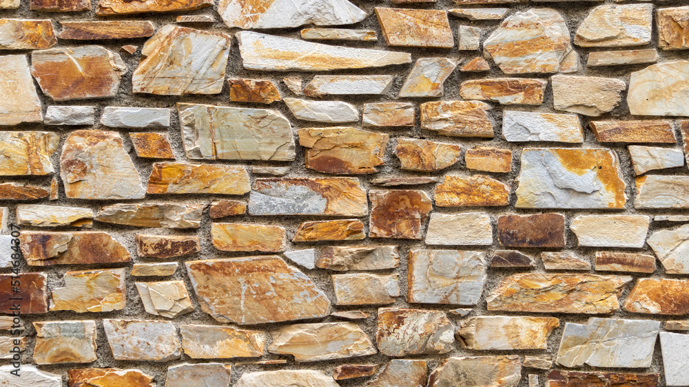Fototapeta premium Nice colorful stone wall in beige, orange tones, close up, background