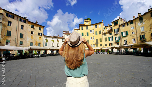 Travel in Italy. Panoramic banner view of young tourist woman visiting the historic city of Lucca in Tuscany, Italy.