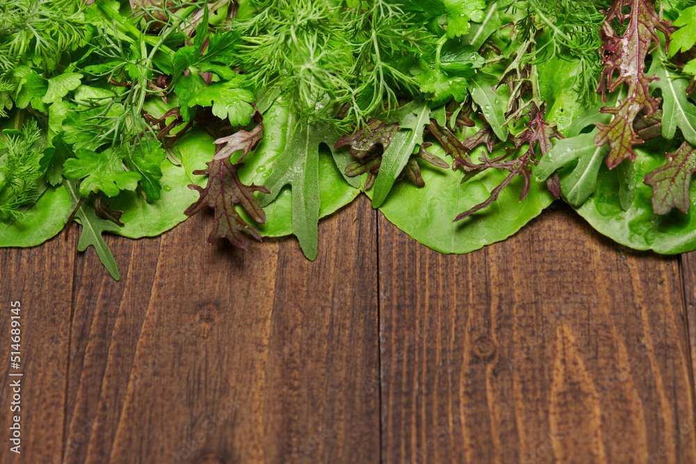 top view of green dill, parsley, salad, herbs and other greens on a dark wooden background, concept of fresh vegetables and healthy food, blank space or copy space for text top view of green dill, parsley, salad, herbs and other greens on a dark wooden background, concept of fresh vegetables and healthy food, blank space or copy space for text