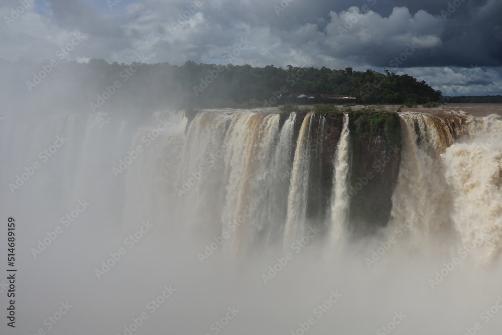 The photo shows a stunning view from the top of the Iguazu Falls — a complex of 275 waterfalls on the Iguazu River, located on the border of Brazil and Argentina The photo shows a stunning view from the top of the Iguazu Falls — a complex of 275 waterfalls on the Iguazu River, located on the border of Brazil and Argentina