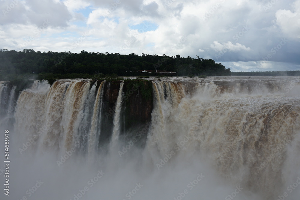 The photo shows a stunning view from the top of the Iguazu Falls — a complex of 275 waterfalls on the Iguazu River, located on the border of Brazil and Argentina The photo shows a stunning view from the top of the Iguazu Falls — a complex of 275 waterfalls on the Iguazu River, located on the border of Brazil and Argentina