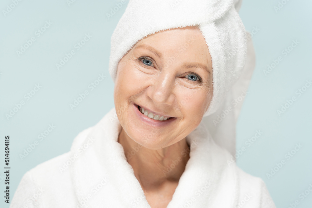 Beauty portrait of senior woman in bathrobe after spa, older beauty face with fresh skin Beauty portrait of senior woman in bathrobe after spa, older beauty face with fresh skin