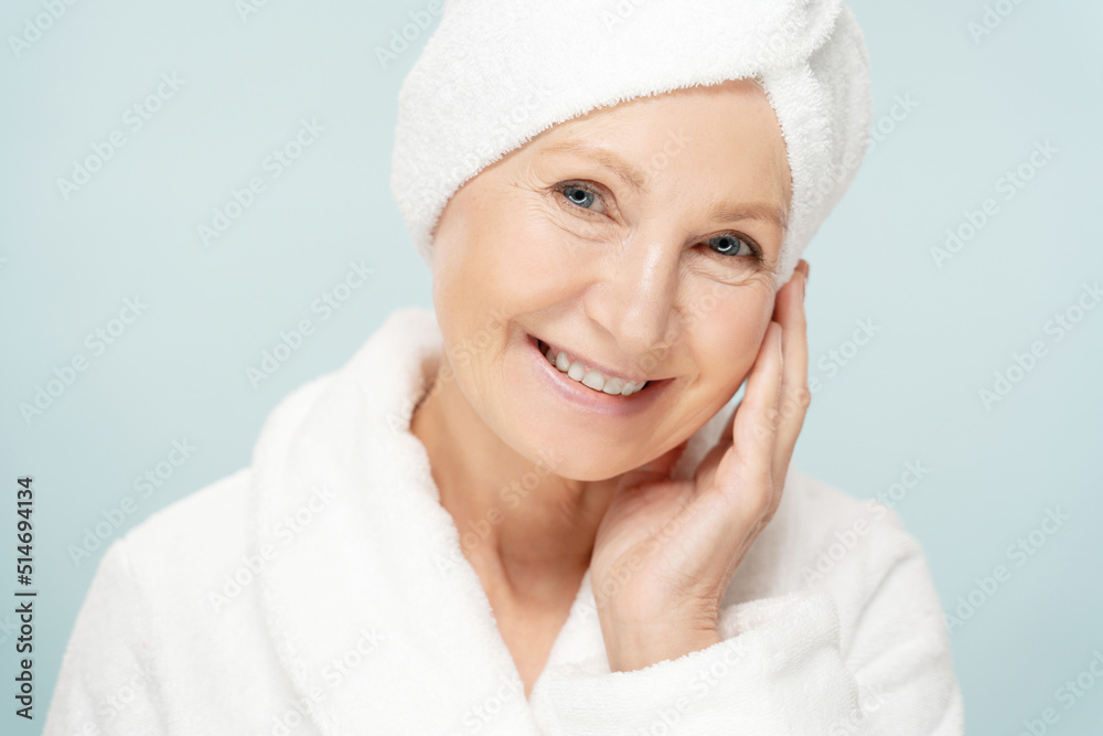 Beauty portrait of mature woman in bathrobe after spa, older beauty face with fresh skin Beauty portrait of mature woman in bathrobe after spa, older beauty face with fresh skin
