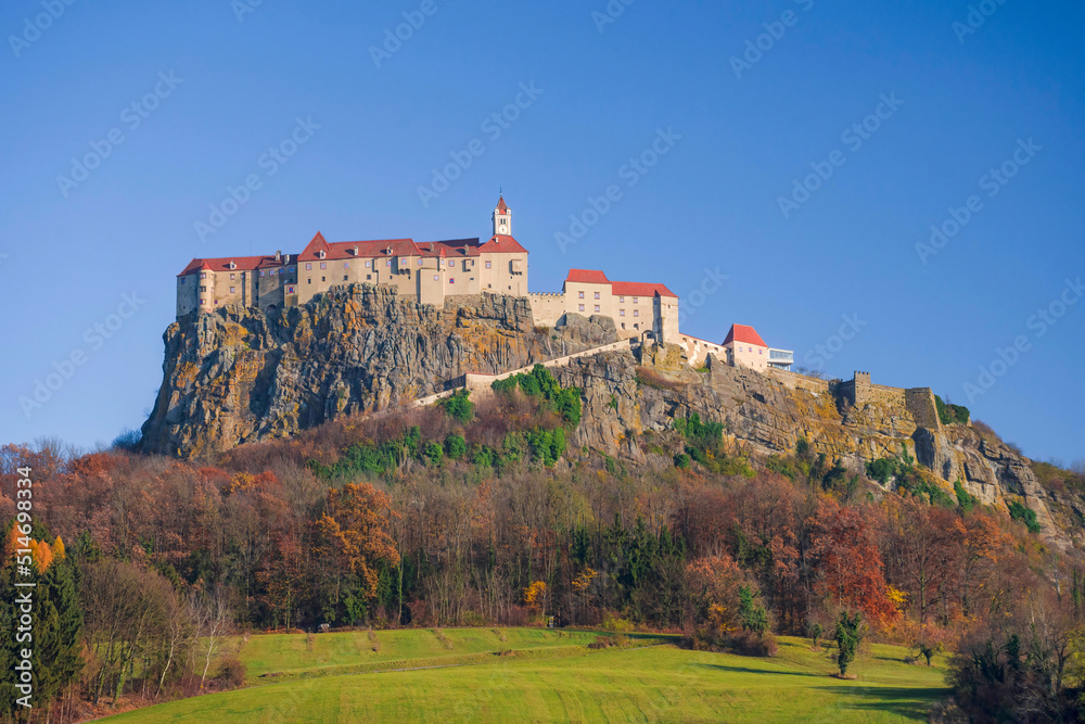 The medieval Riegersburg Castle on top of a dormant volcano, surrounded by beautiful autumn landscape, famous tourist attraction in Styria region, Austria The medieval Riegersburg Castle on top of a dormant volcano, surrounded by beautiful autumn landscape, famous tourist attraction in Styria region, Austria