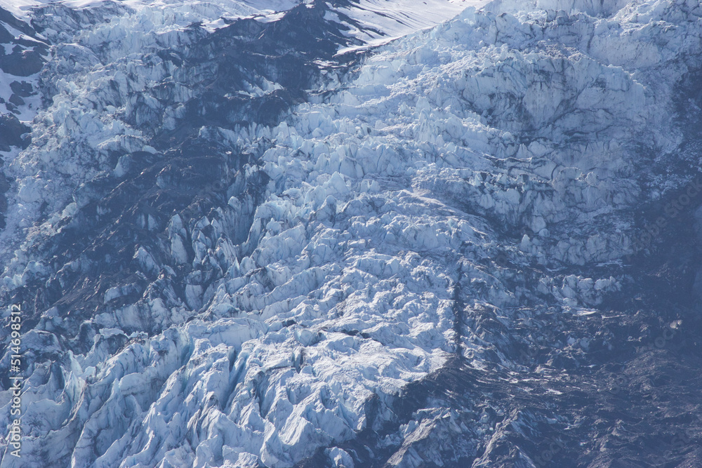Large valley of ice leading up into the mountains from the water Large valley of ice leading up into the mountains from the water
