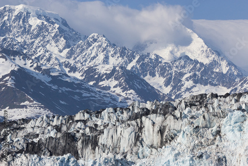 Ridgeline of a tidewater glacier in front of an Alaskan mountain range © Calen