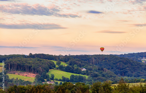 Green Hills and Forests of Velbert Langenberg, Germany with a Hot Air Balloon in the Sky