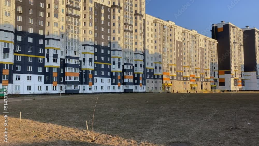 Long perspective of a high-rise building in the middle of an empty field. The lychee of the sun slowly descends across the building. Long perspective of a high-rise building in the middle of an empty field. The lychee of the sun slowly descends across the building.