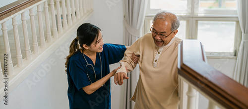 Nurse helping the elderly walk up the stairs