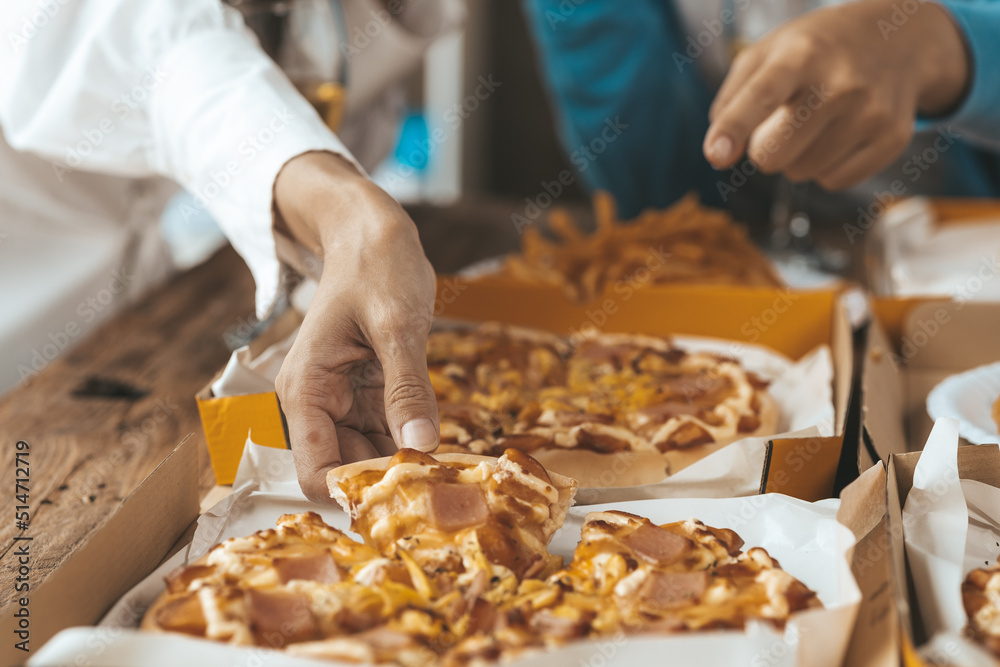Hands people picking up pizza on a tray to eat, startup company parties, New Year's parties, company annual gatherings, alcoholic beverages. Company employee party catering ideas, pizza celebrations.