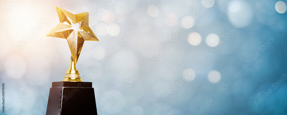golden trophy award bokeh soft  blue background. copy space for text. Winner or 1st place gold trophy award concept - obrazy, fototapety, plakaty 