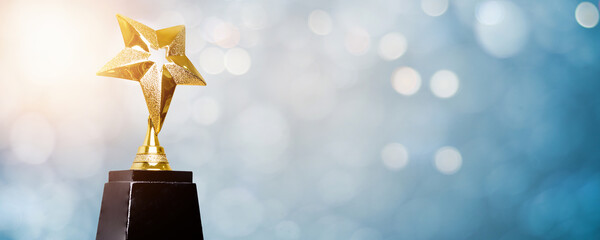 golden trophy award bokeh soft  blue background. copy space for text. Winner or 1st place gold trophy award concept
