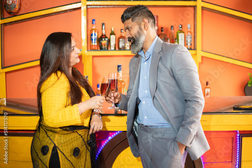 Canvas Print Happy indian business people holding glass of wine and champagne in hand, Man and woman corporate party to celebrate company success