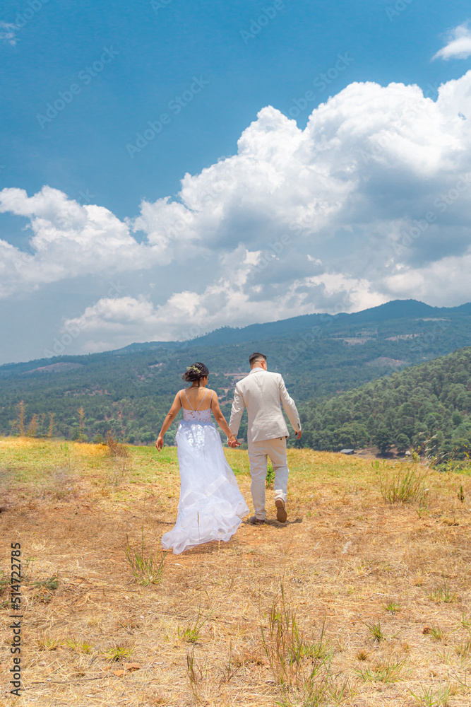 Groom and bride in their weeding day on the forest in the countryside