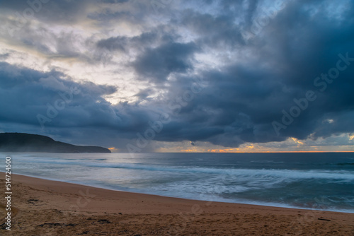 Overcast sunrise seascape with rain clouds