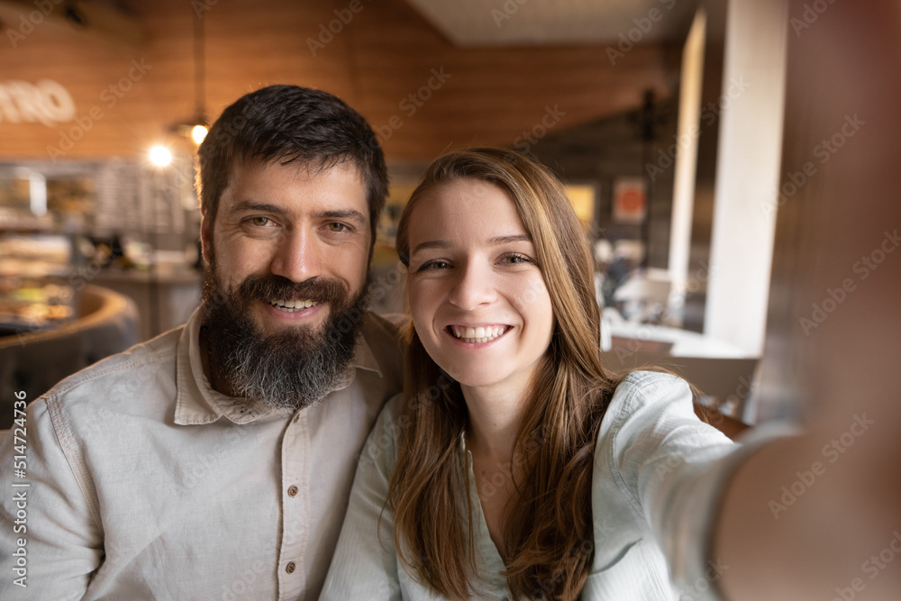 Smiling beautiful woman and her handsome boyfriend. Couple at their date in restaurant. Happy family. They taking Pov selfie at cafe Smiling beautiful woman and her handsome boyfriend. Couple at their date in restaurant. Happy family. They taking Pov selfie at cafe