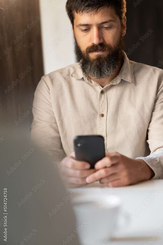 Portrait of man using smartphone in cafe, business freelance Portrait of man using smartphone in cafe, business freelance