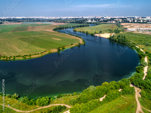Wide river flowing between fields