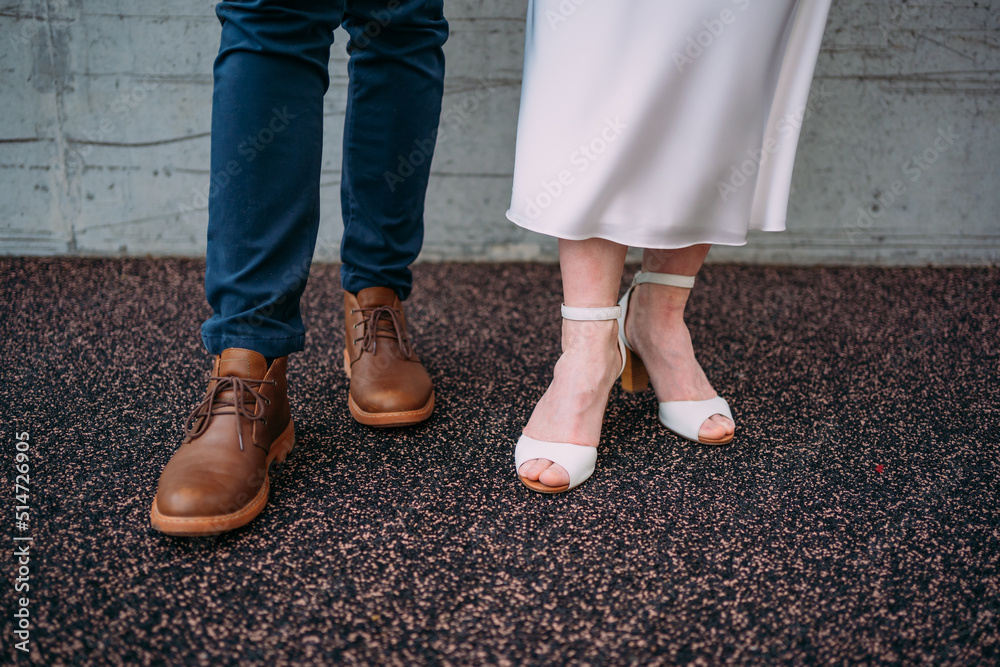 legs of a person in shoes, groom and bride