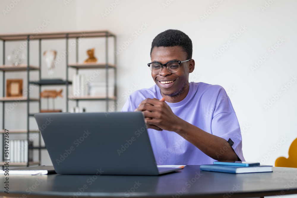 African businessman happy on a video conference, talking in office room African businessman happy on a video conference, talking in office room