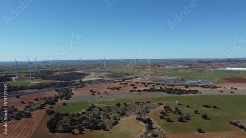 Large wind turbines with blades in field aerial view bright orange sunset blue sky wind park drone turn.  Alternative energy (ID: 514727541)