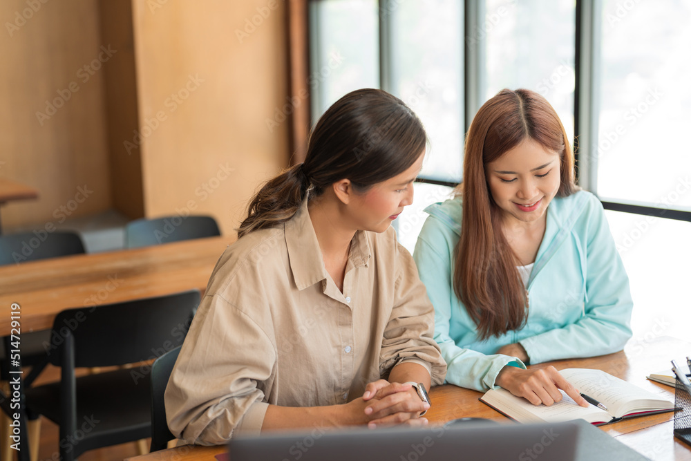 Education concept, Teenage girl point on textbook and asking question tutor while study tutorial Education concept, Teenage girl point on textbook and asking question tutor while study tutorial