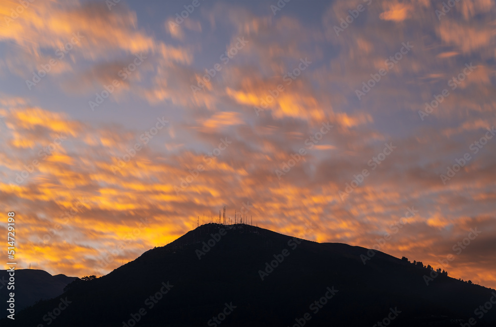 Long exposure sunset with the antenna peak (3920m altitude) of the Pichincha volcano, Quito, Ecuador.