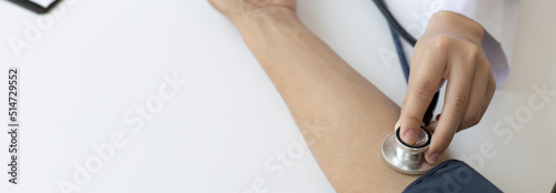 Female doctors use blood pressure monitors and stethoscope to measure pulse Diagnose the patient's disease in a modern hospital medical laboratory, Medical treatment and health care concept.